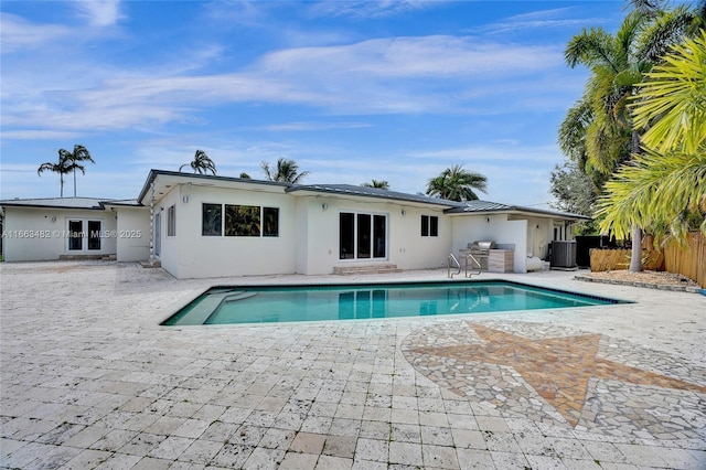 view of swimming pool with a patio and central AC unit