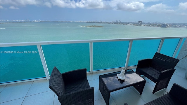 balcony with a water view and outdoor lounge area