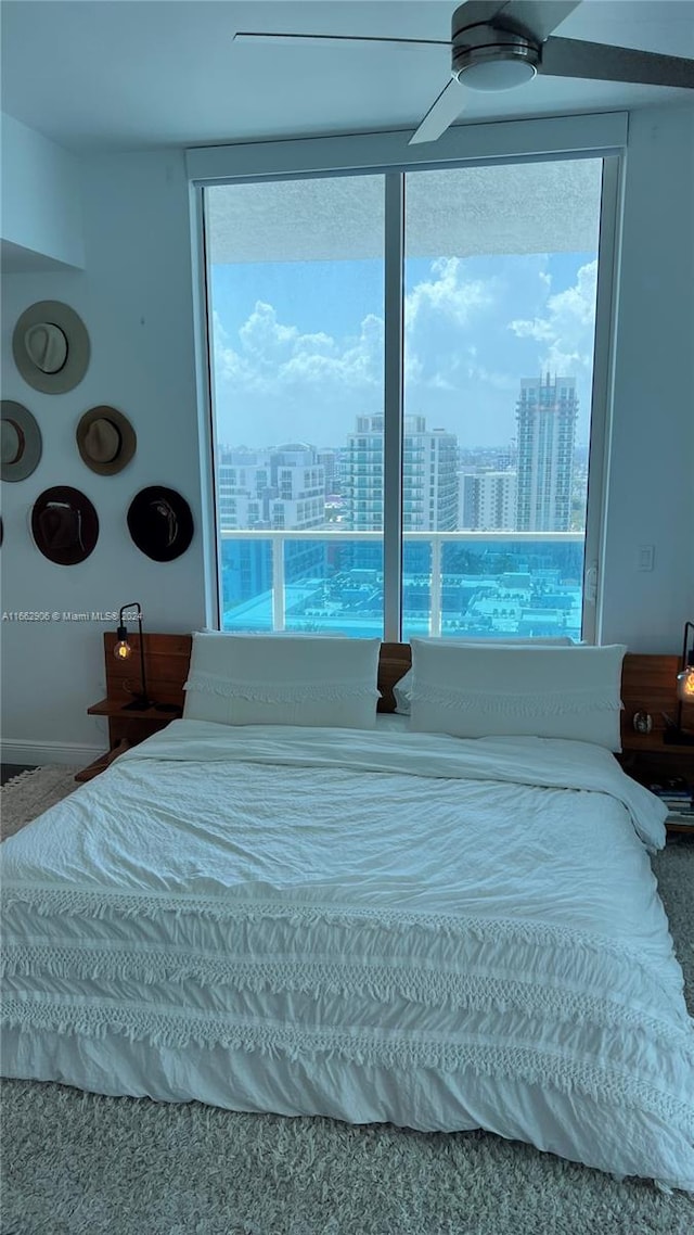 bedroom featuring ceiling fan and multiple windows