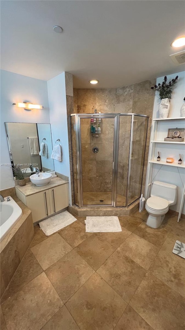 full bathroom with shower with separate bathtub, vanity, and toilet