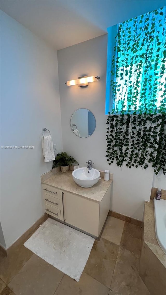 bathroom with vanity and a bathtub