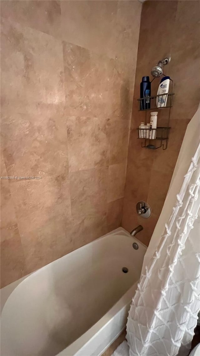 bathroom with shower / bathtub combination with curtain