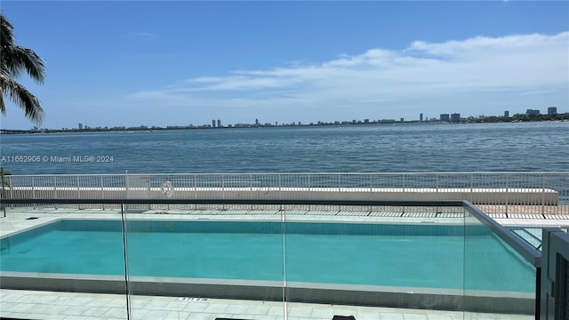 view of swimming pool with a water view