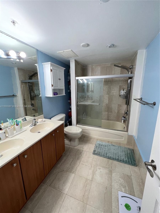 full bathroom featuring enclosed tub / shower combo, vanity, and toilet