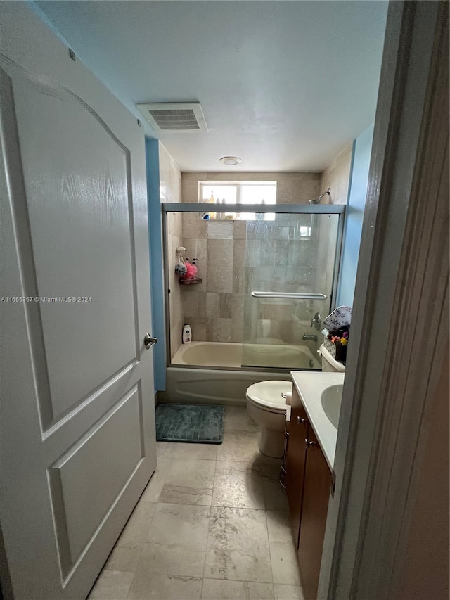 full bathroom featuring shower / bath combination with glass door, vanity, and toilet