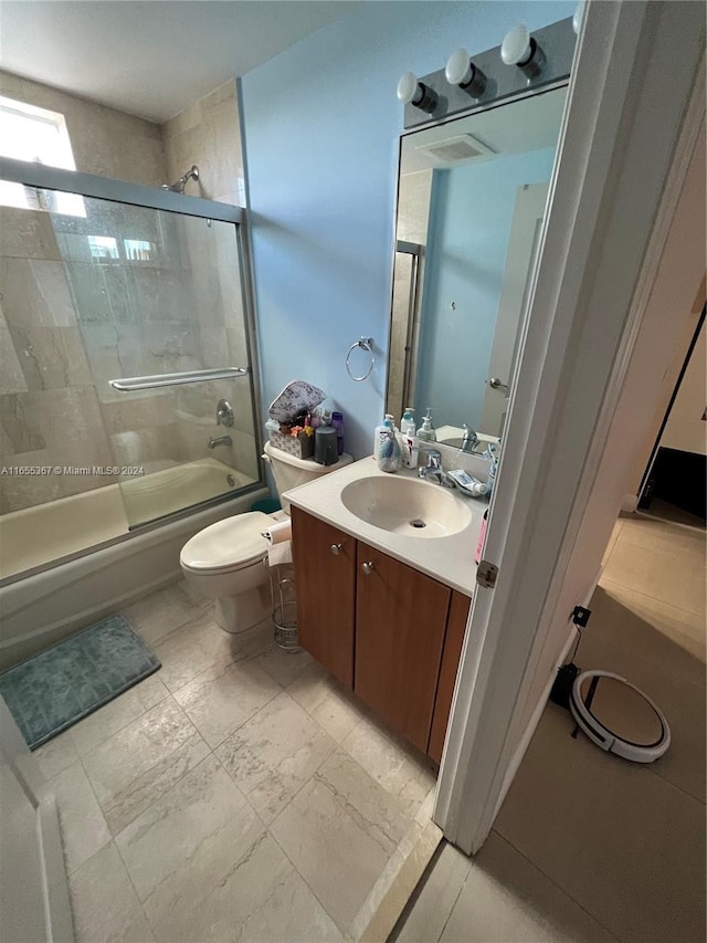 full bathroom with vanity, combined bath / shower with glass door, and toilet