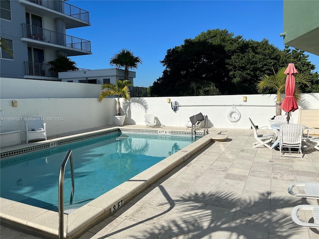 view of swimming pool with a patio