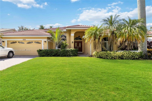 mediterranean / spanish-style home with a garage and a front yard