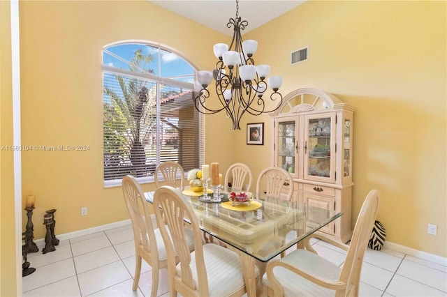 tiled dining room featuring a chandelier