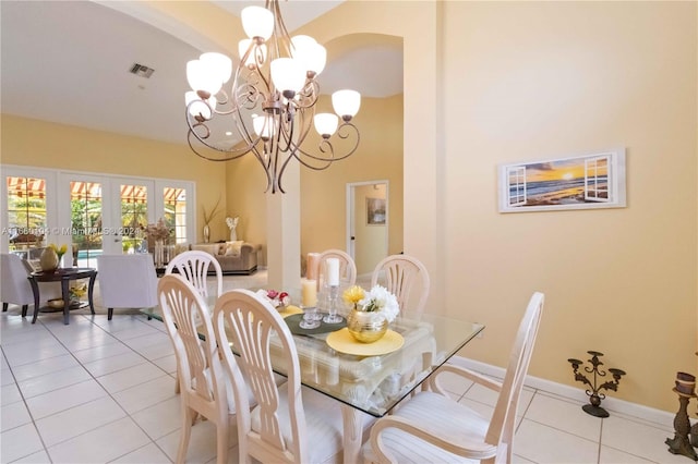 dining room featuring french doors, a notable chandelier, and light tile patterned floors