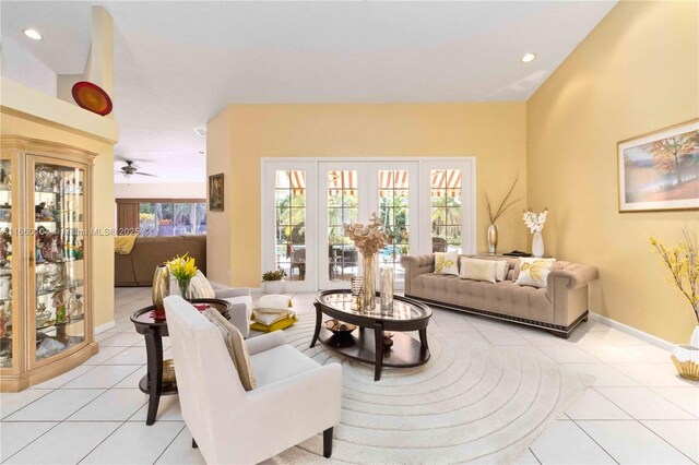 tiled living room with ceiling fan and french doors