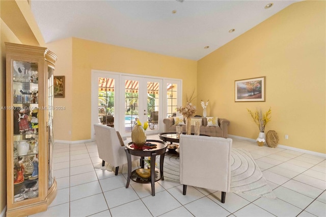 living room with french doors, light tile patterned floors, and vaulted ceiling