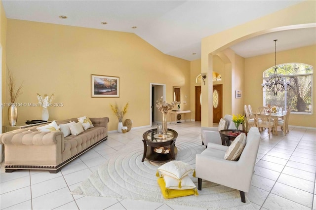 living room with high vaulted ceiling, light tile patterned floors, and an inviting chandelier