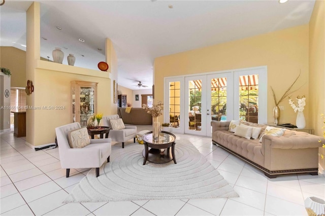 living room featuring french doors, vaulted ceiling, ceiling fan, and light tile patterned flooring