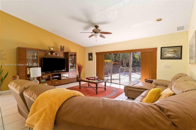 living room with light tile patterned floors, vaulted ceiling, a textured ceiling, and ceiling fan