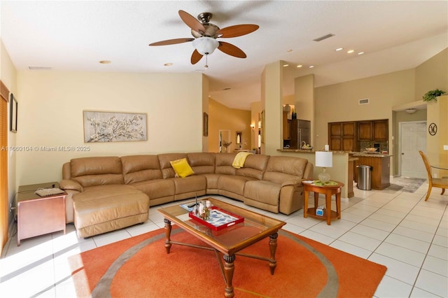 tiled living room with vaulted ceiling and ceiling fan