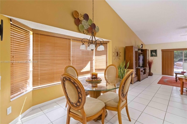 tiled dining area featuring high vaulted ceiling and a chandelier