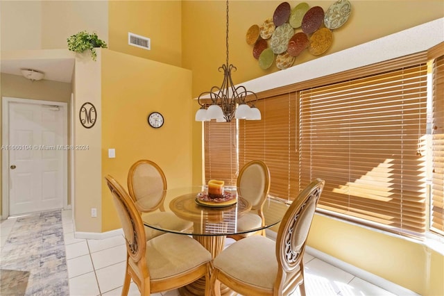 tiled dining space featuring an inviting chandelier