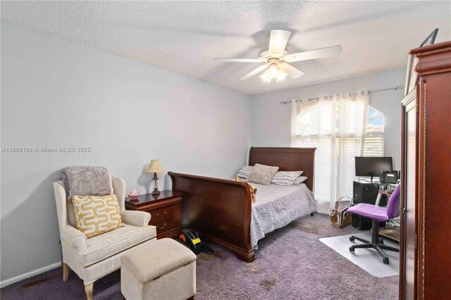 bedroom featuring ceiling fan, a textured ceiling, and dark carpet