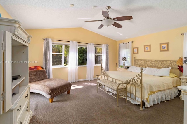 bedroom featuring carpet floors, ceiling fan, vaulted ceiling, and a textured ceiling