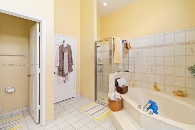 bathroom featuring separate shower and tub and tile patterned flooring