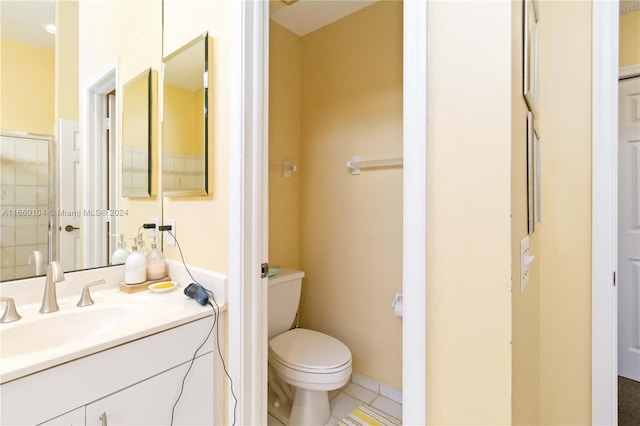 bathroom with tile patterned flooring, vanity, and toilet