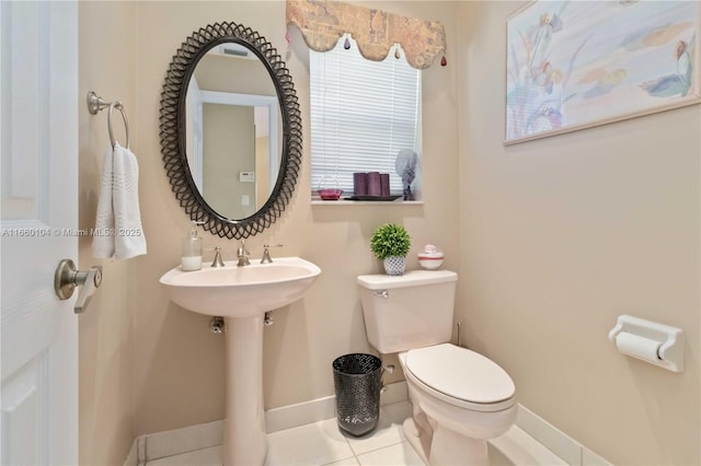 bathroom featuring tile patterned flooring and toilet