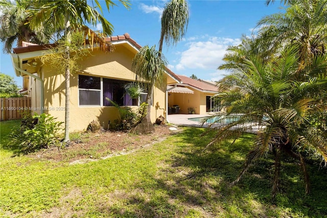 back of property featuring a yard and a patio area