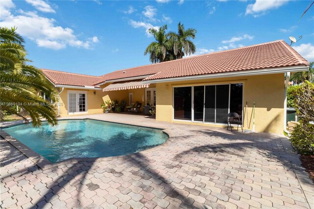 view of pool with a patio area and central air condition unit