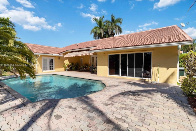 back of property featuring french doors, cooling unit, and a patio area