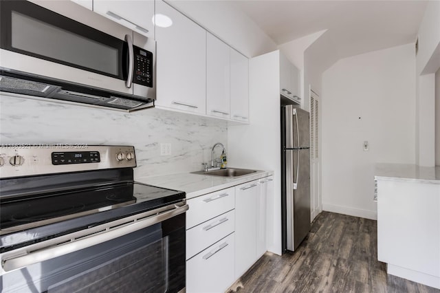 kitchen featuring appliances with stainless steel finishes, sink, and white cabinets