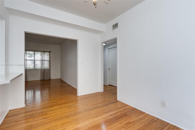 spare room featuring light hardwood / wood-style floors