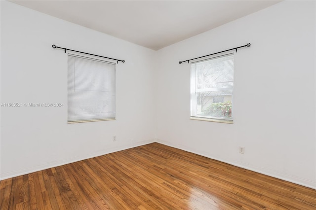 unfurnished room with hardwood / wood-style flooring