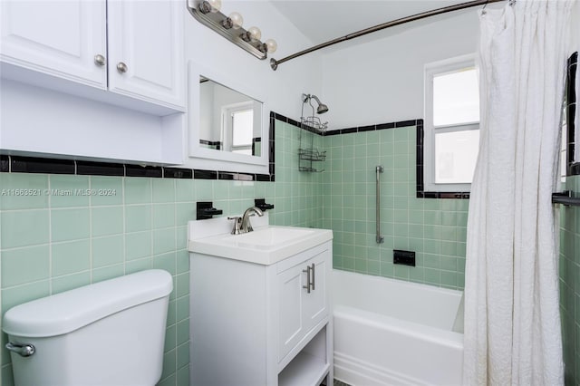 full bathroom with shower / bath combo with shower curtain, tile walls, vanity, and toilet