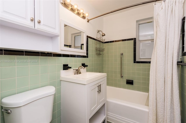 full bathroom with shower / bath combination with curtain, tile walls, vanity, and toilet