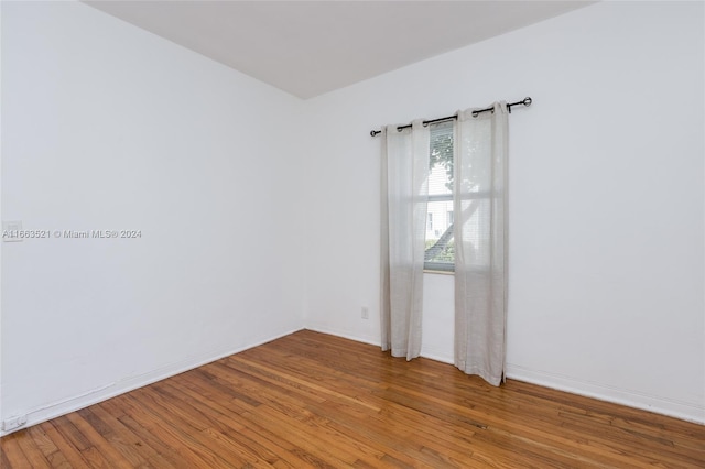 spare room featuring wood-type flooring