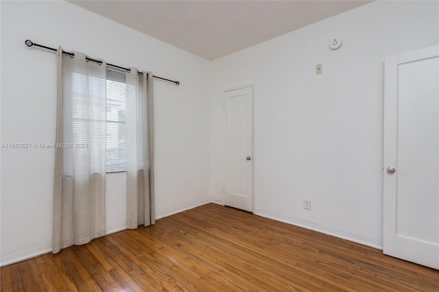 empty room with wood-type flooring