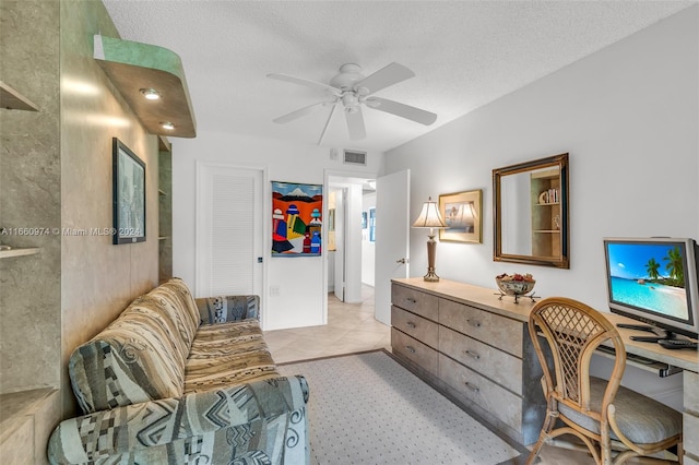 office area with ceiling fan, light tile patterned floors, and a textured ceiling