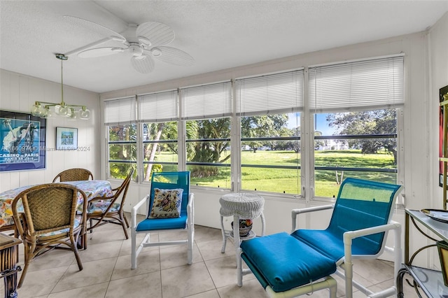 sunroom / solarium featuring ceiling fan