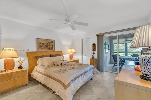 bedroom with a closet, ceiling fan, access to exterior, and light tile patterned floors