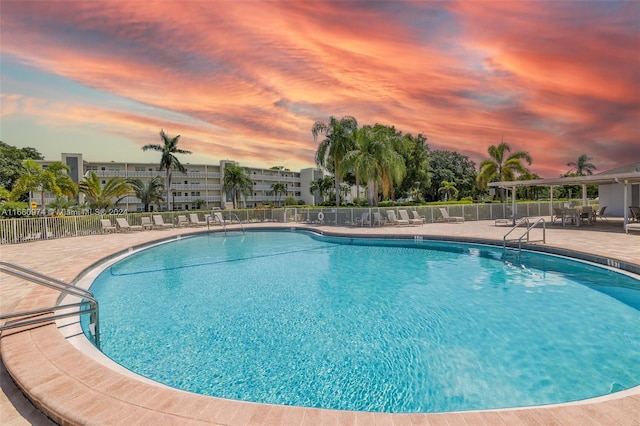 pool at dusk with a patio