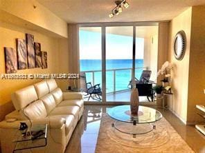 living room featuring a water view and expansive windows