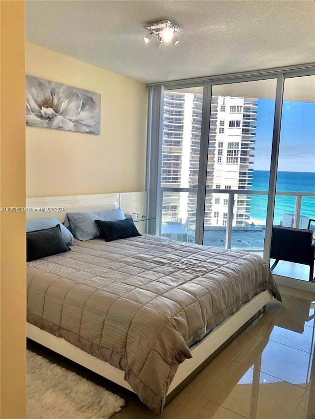 tiled bedroom featuring a water view