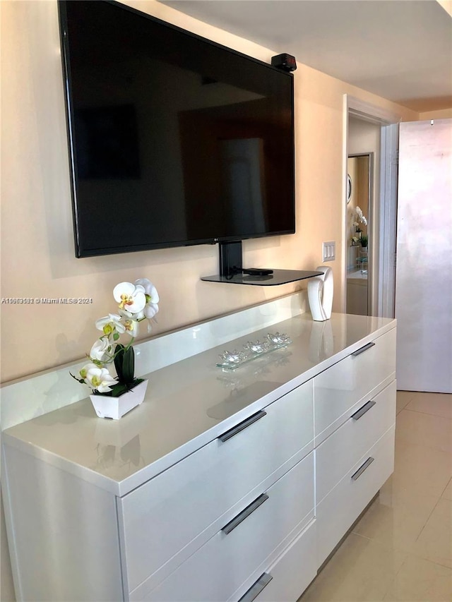 kitchen with white cabinets and light tile patterned floors