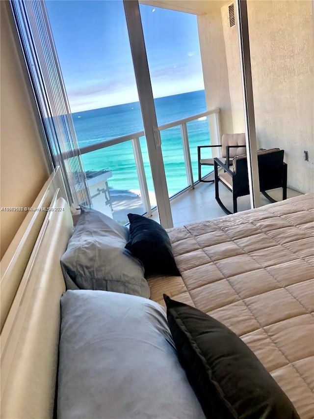 bedroom with a beach view and a water view