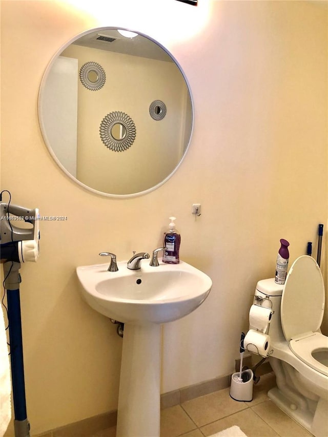 bathroom with toilet and tile patterned floors