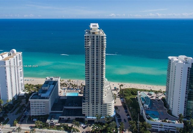 drone / aerial view with a beach view and a water view