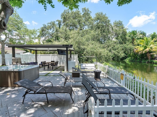 view of patio / terrace featuring a hot tub and fence