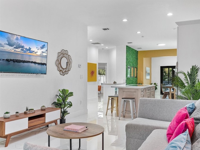 living room featuring a wealth of natural light, marble finish floor, visible vents, and recessed lighting