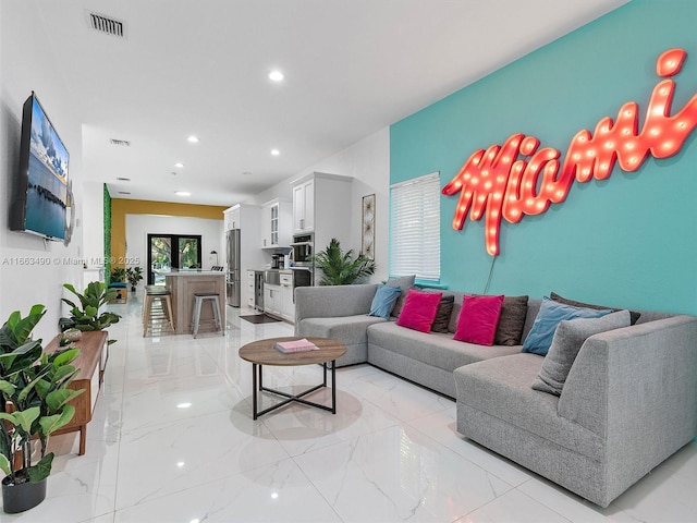 living room featuring marble finish floor, visible vents, and recessed lighting